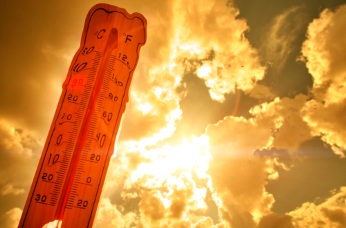 Red melting thermometer against the hot sun.