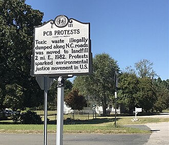 A sign in Afton, North Carolina that states, "Toxic waste illegally dumped along N.C. roads was moved to landfill  miles East, 1982. Protests sparked the environmental justice movement in the U.S."
